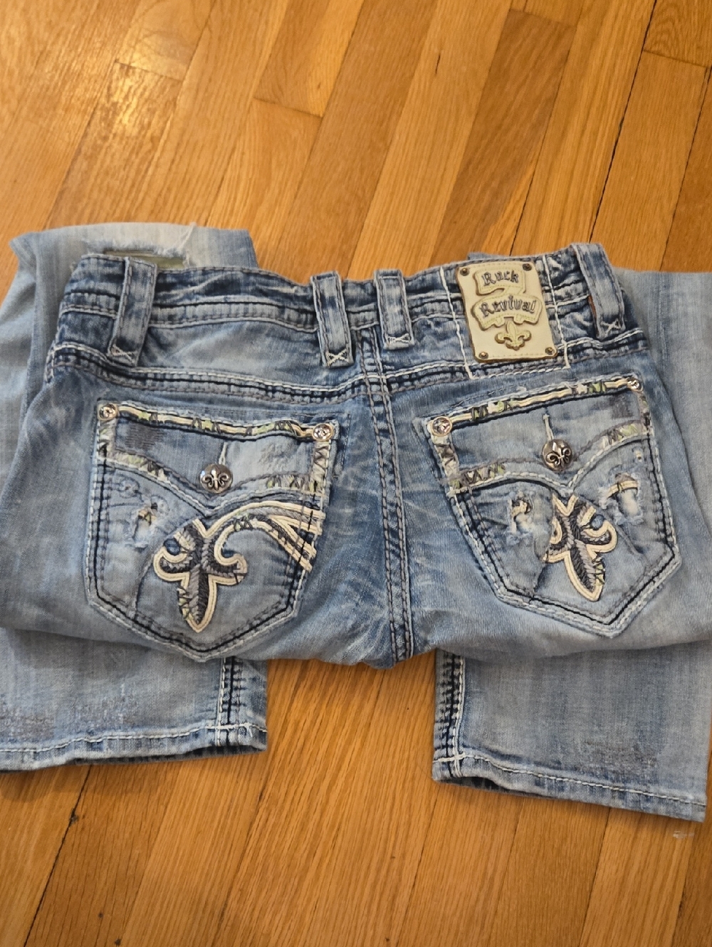 Rock Revival Light Blue Bootcut Jeans with Embroidered Fleur-de-Lis Pockets